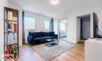 Bright living room with a sofa and TV