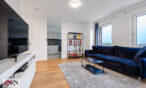 Bright living room with a sofa and TV